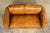 French Art Deco leather club sofa sourced in Paris, dating to the late 1920s–1930s. The sofa features a compact, squared...