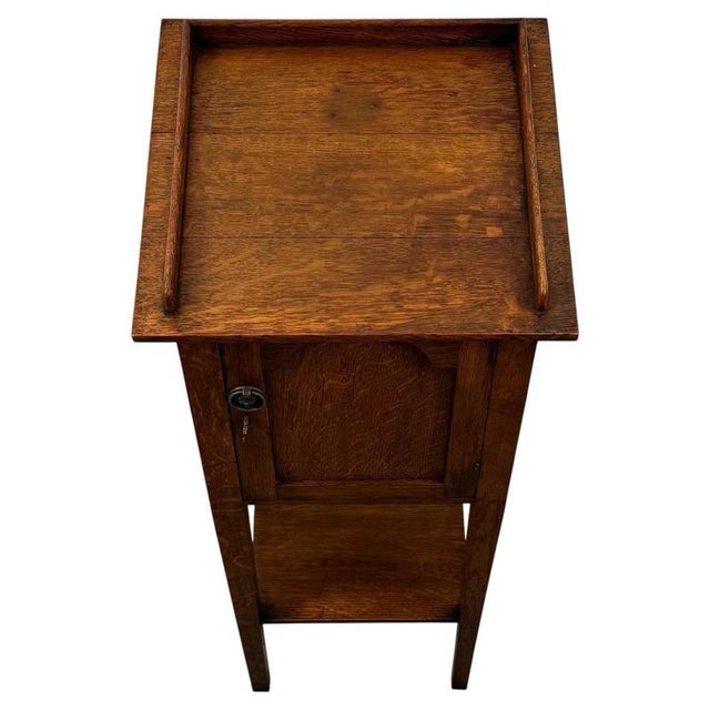 A charming early 20th-century English Arts and Crafts cabinet, finely crafted from oak and distinguished by its unusually...