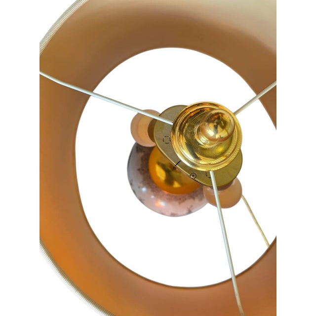 A magnificent vintage table lamp from the 1950s or 1960s, featuring an intricately crafted brass base in the Rococo style...