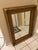 Beautiful substantial mirror featuring an elaborate antique-style gold gilt frame with intricate leaf, berry and floral...