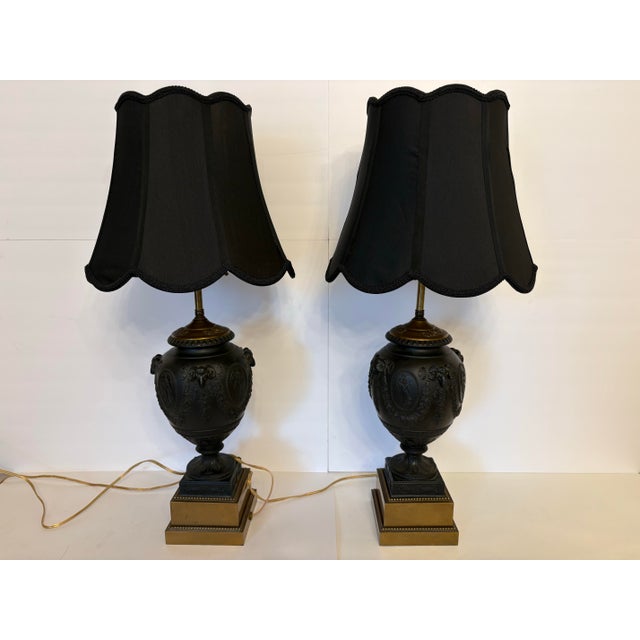 The bodies of these Basalt lamps are crafted from black Basalt, a fine grained, unglazed stoneware fabricated by Josiah...