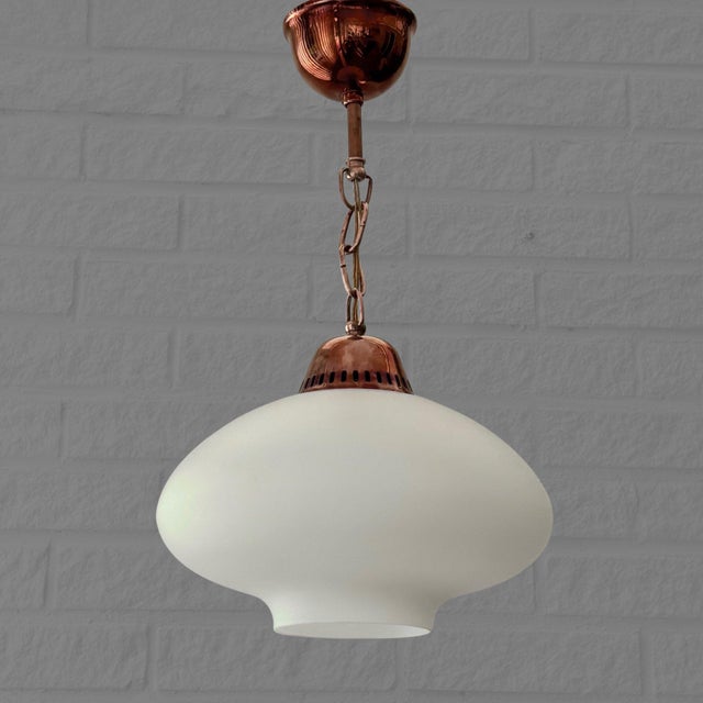 A refined Scandinavian pendant lamp produced by an unidentified Swedish manufacturer in the 1950s. The lamp features a...