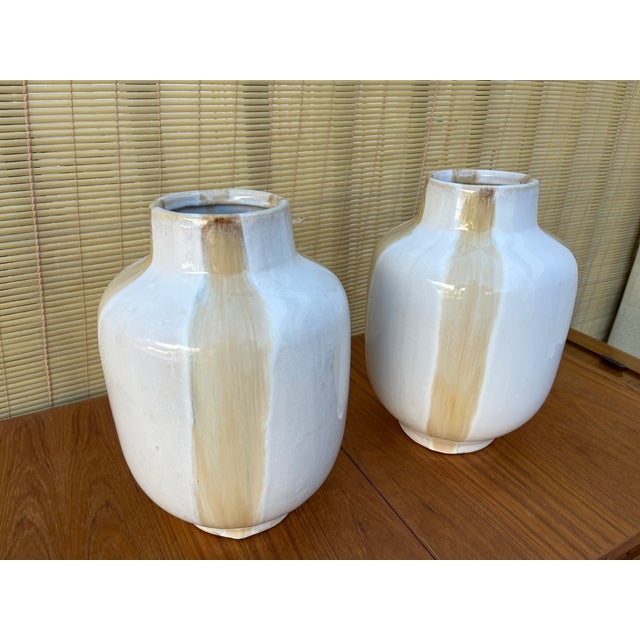 A Pair of Mid-Century Modern Two-Tone Studio Pottery Ceramic Vases. Circa 1970s Features beige drips with hints of gray...