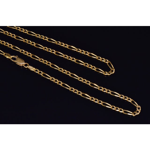 Top-quality Italian solid 18K yellow gold Figaro chain necklace. This impressive 30-inch chain by Olimpia Catene SRL...