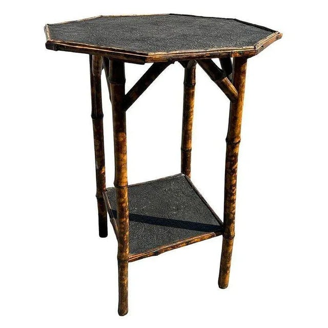 Late Victorian tiger bamboo side table with intricate embossed Paisley block pattern octagonal tabletop. The table...