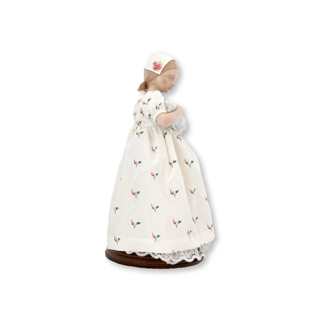 1983 Bing & Grondahl porcelain figure titled “Mary The Doll & Baby,” depicting a young girl in a delicate floral dress...