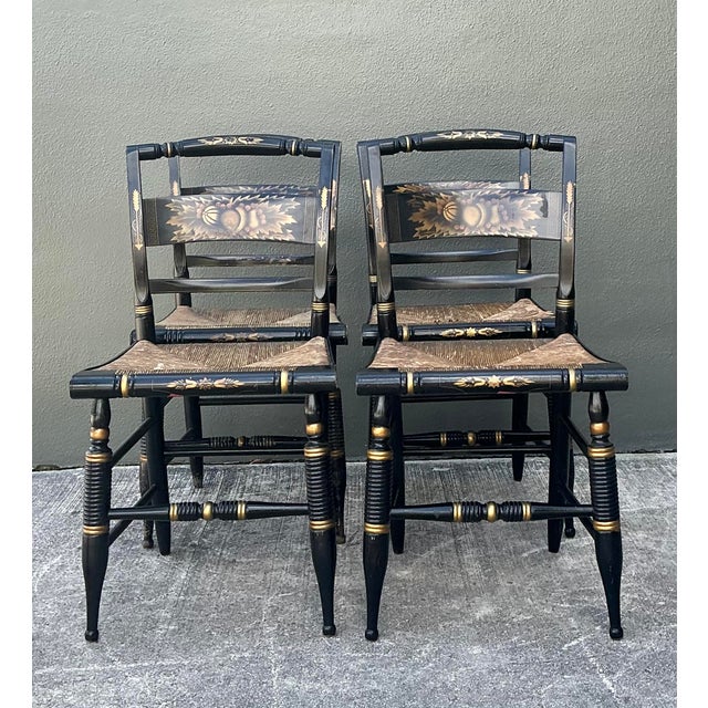 This quintessential set of four L. Hitchcock dining chairs represents a timeless staple of American artisan furniture....