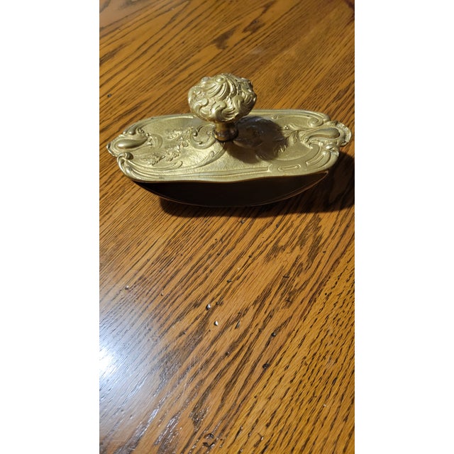 Rare fin, decorated brass inkwell blotter. The top is decorated with ornate floral and spanish wands designs.