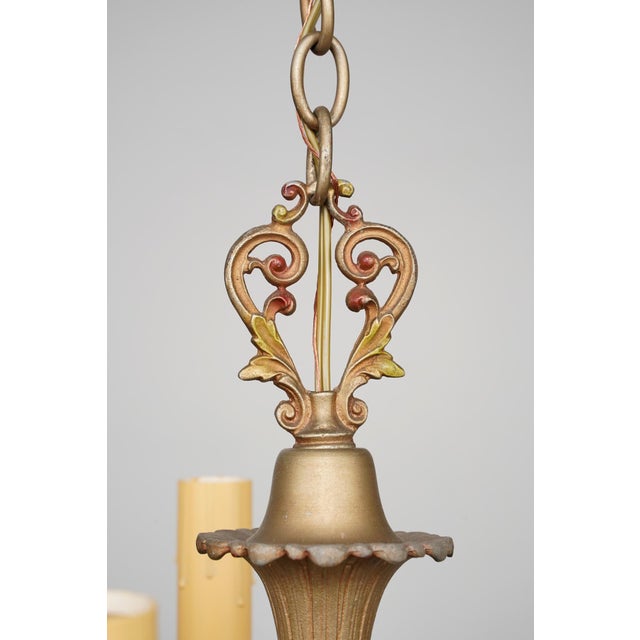 This five-arm chandelier is a beautiful example of early-to-mid 20th-century craftsmanship, featuring a robust frame of...
