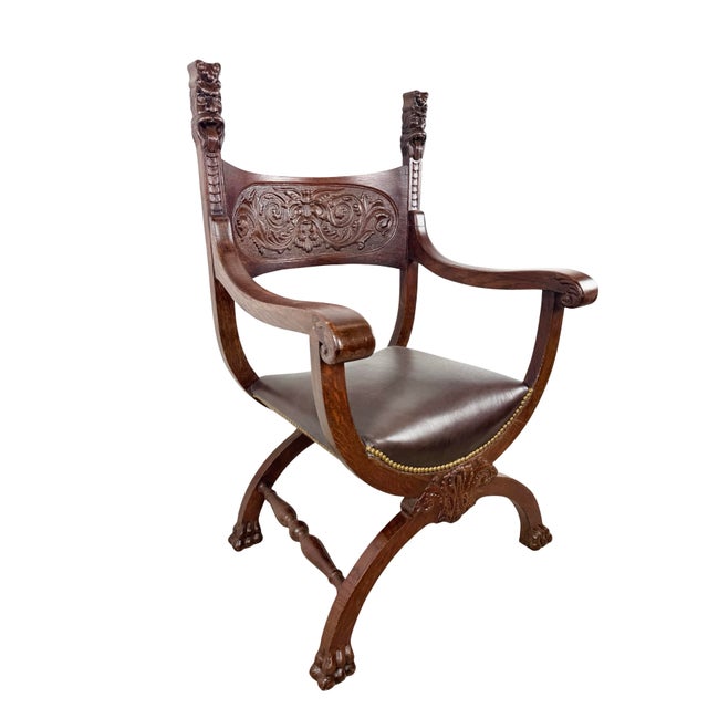 A sculptural vintage Savonarola chair in the Renaissance Revival tradition, featuring the distinctive X-frame construction...