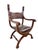 A sculptural vintage Savonarola chair in the Renaissance Revival tradition, featuring the distinctive X-frame construction...