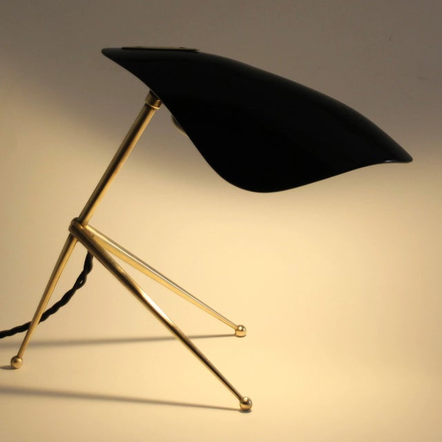 Rare black mid-century modern bedside lamp or table lamp with an adjustable plastic shade. Probably manufactured by wkr...