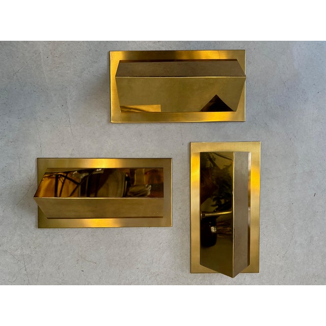 Set of 3 vintage Liro Belgium wall lamps. Minimalist and very high-quality design. Brass. White colored inside for optimal...