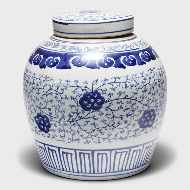 This round, porcelain storage jar is brightly glazed in the classic blue-and-white manner with allover pattern of trailing...