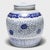 This round, porcelain storage jar is brightly glazed in the classic blue-and-white manner with allover pattern of trailing...