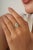 This cocktail ring features a 0.2 carat pear-shaped emerald set in 18k white gold. The emerald measuring 3.2 x 5 mm,...