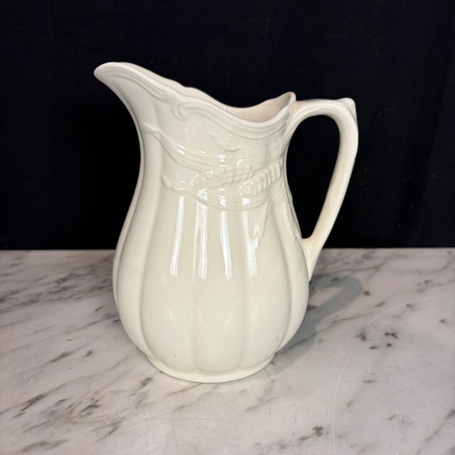Antique English ironstone pitcher by Royal Staffordshire Pottery, Wilkinson Ltd., featuring a beautifully molded form with...