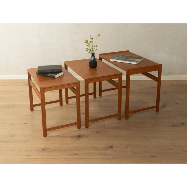 1960s Nesting Tables Elegant Design: The side tables impress with their clean lines and slightly raised edges, which...