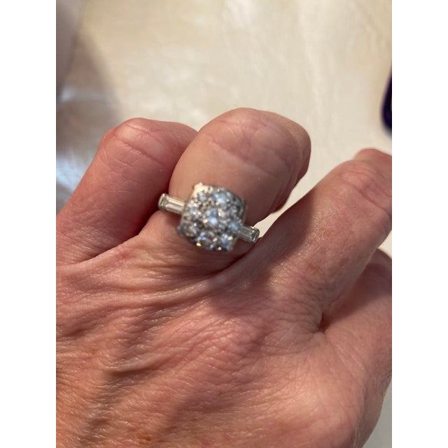 Gorgeous vintage estate platinum and diamond cluster ring with two side baguette diamonds. Size 4.5. Marked for platinum....
