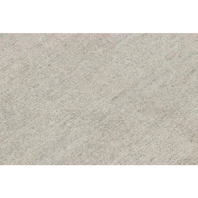 Made with hand-knotted silk, this 10x12 oversized contemporary rug is a custom rug design from Rug & Kilim’s Textural rug...