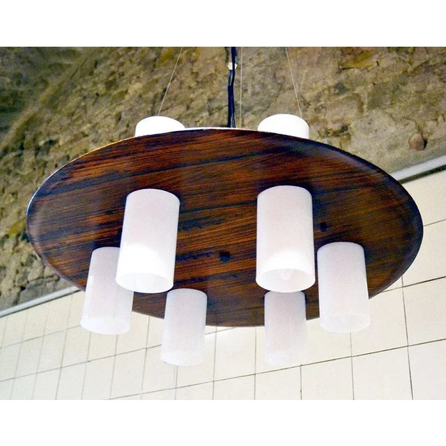 1960's chandelier Stilux production composed by a rosewood disk and six cylindrical opaline Acrylic Glass lampshades with...