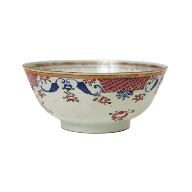 A mid to late 18th century porcelain punch bowl. Hand painted overglaze in famille rose motif with floral garlands and a...