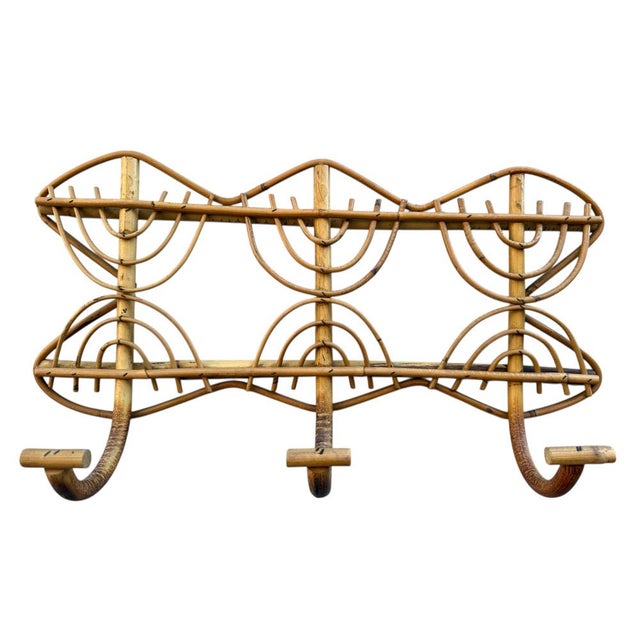 1960s rattan wall-mounted coat rack in a rectangular shape with three hooks. It embodies the style of the Italian Riviera...