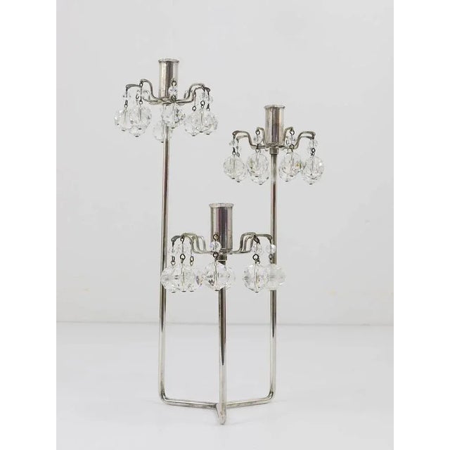 A beautiful modernist candleholder, executed by Lobmeyr Vienna in the 1950s. Silver-plated, with sparkling crystals. Good...