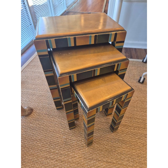 A three piece nesting table made of wood. This nesting table has a lacquer finish which makes things easy to clean. The...