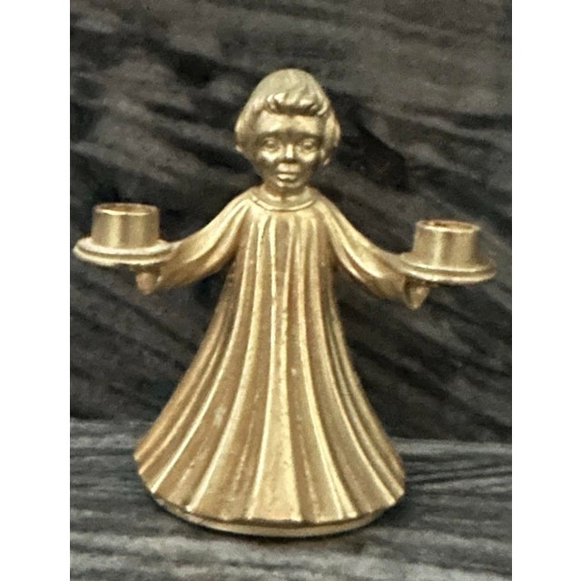 This vintage Italian brass gilded dual candle holder features a choir boy (or angel) design, perfect for Christmas or any...