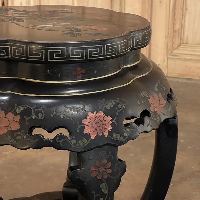 Mid-Century Chinese Hand-Painted Black Lacquer Lamp Table features a classic urn form with five "petals" to the flower...