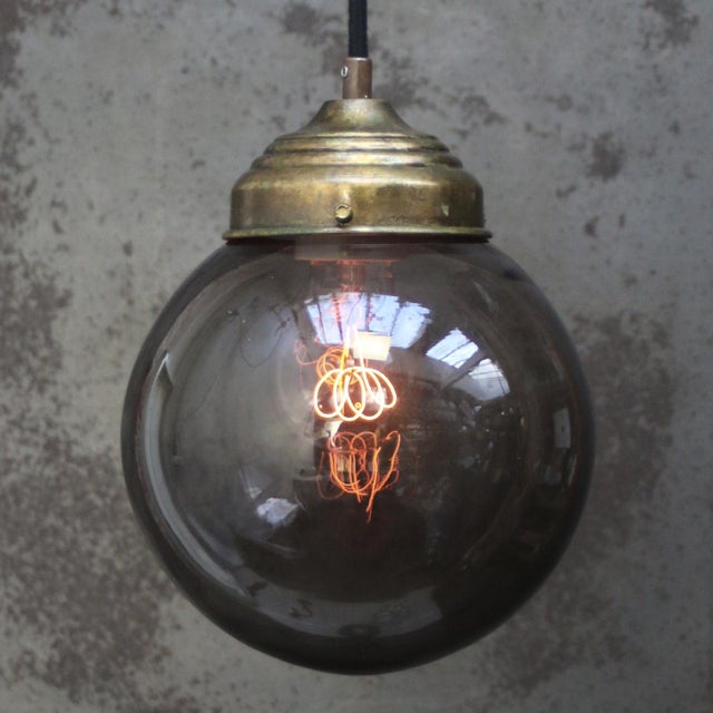 Smoked glass pendant. Brass top. 2 meter black cotton flex E27 / E26 Up to 250V (Europe/UK Standard).The wiring of this...