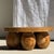 Mini minimalist stool with five teak ball legs. Diameter: 34.5cm; Height: 15cm. Weight: 4kg. Elegant and inviting...