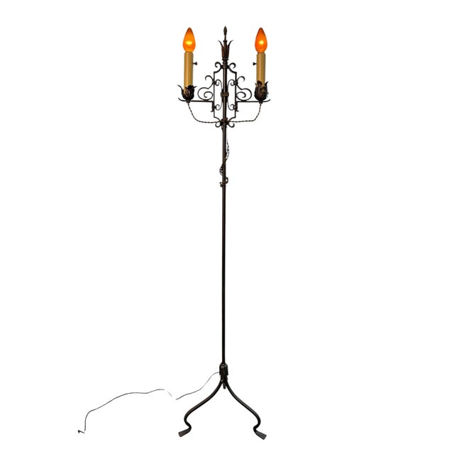Wrought Iron Floor lamp in the Spanish Revival style with new finish and electrical. Candle covers are new. We used the...