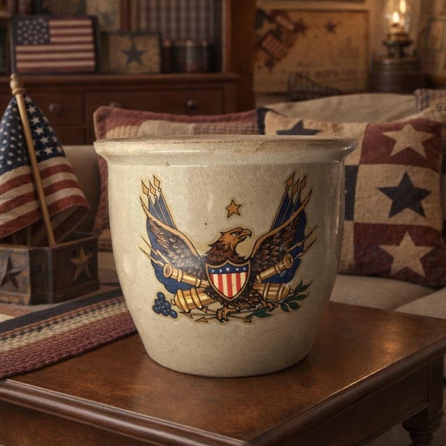 This antique stone ware crock features an early US Federal Patriotic Eagle and Canons Flag pattern. Measuring 8 7/8 inches...