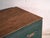 This antique Chinese trunk in green-lacquered elm is a dowry chest with a sliding lid and a floral front on a green...