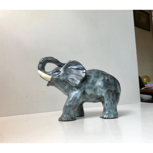 Michael Andersen Elephant executed in glazed ceramic. Very rare version with blue and black glaze. It is imprinted with...