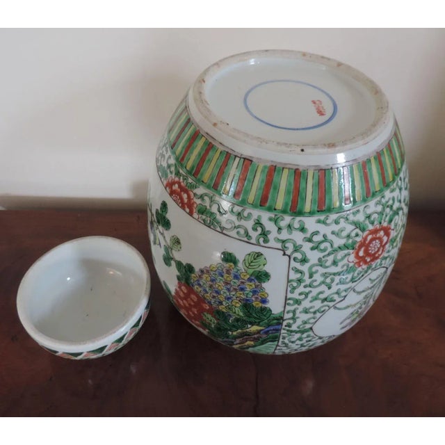 A large bulbous 19th c. Chinese famille verte porcelain vase and cover. Decorated with panels of birds and flowering...