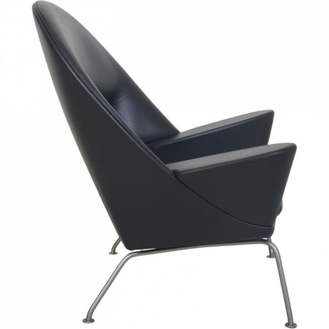 Hans wegner ch468 oculus chair with a steel frame, upholstered with new black classic semi aniline leather. The chair is...
