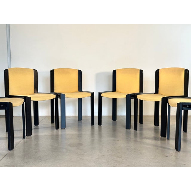 Set of 6 black lacquered wood chairs with yellow fabric seat and backrest, designed by Joe Colombo in 1966 for Pozzi...