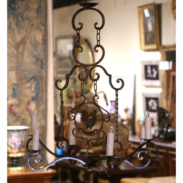 A proud rooster silhouette framed by sweeping scrollwork gives this distinctive chandelier its unmistakable French country...