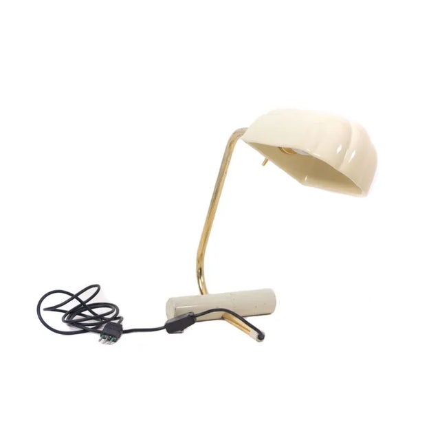 Table or Desk Lamp with brass structure and white lacquered ceramic lampshade, Italy 1970s/1980s. It has a cylindrical...