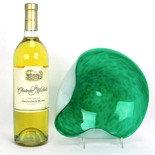 A vintage mid-century handmade Murano art glass bowl or ashtray from Italy, featuring an asymmetrical pinched shape, a...