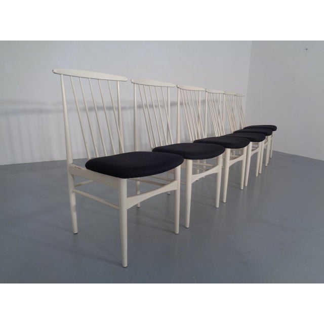 Six high-backed chairs by Ernst Martin Dettinger from the 1960s. Reupholstered in black. Showing signs of wear in the form...