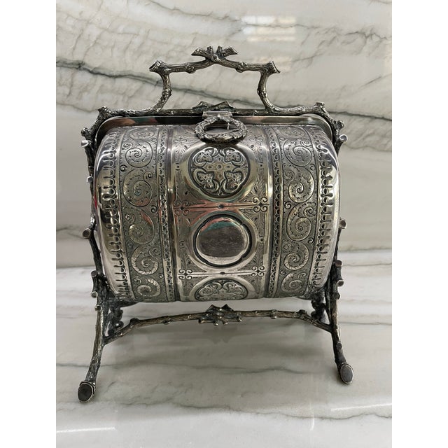 This Antique Victorian Folding Silver Plated Biscuit Box/Muffin Warmer is a very ornate piece, likely made by Fenton...