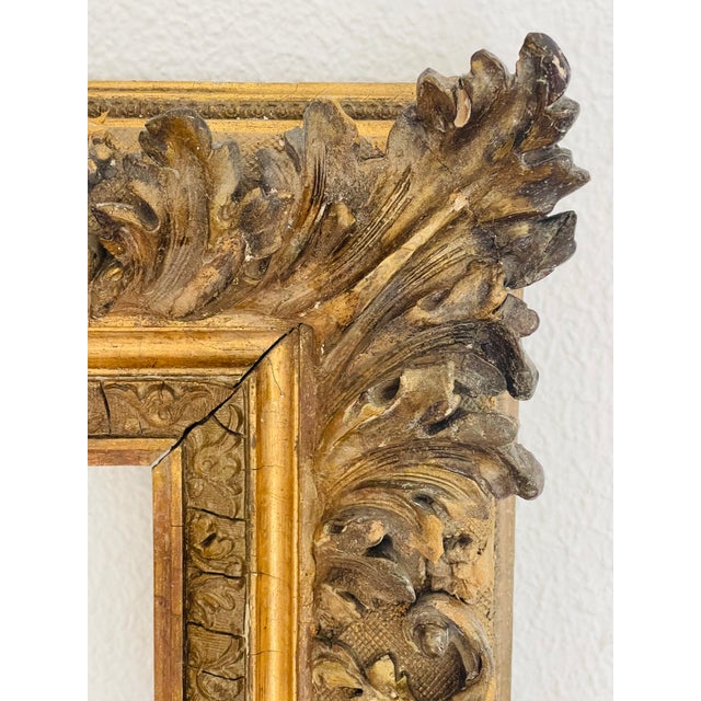 Early 19 th c European richly ornate gold tone mirror frame. Outside dimensions- 105 cm by 65 cm, Inside - 60 cm by 55 cm