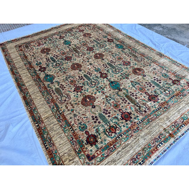 Persian Bakshaish design hand-knotted rug featuring large-scale botanical column motifs in terracotta, rust, and teal...
