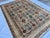 Persian Bakshaish design hand-knotted rug featuring large-scale botanical column motifs in terracotta, rust, and teal...