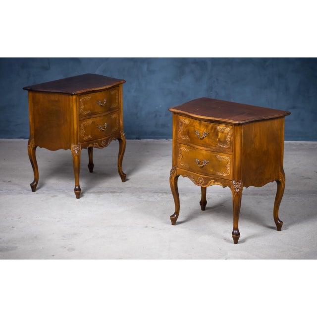 A pair of French Louis XV style bedside tables from the early 20th century. This pair of French 'tables de chevet' was...
