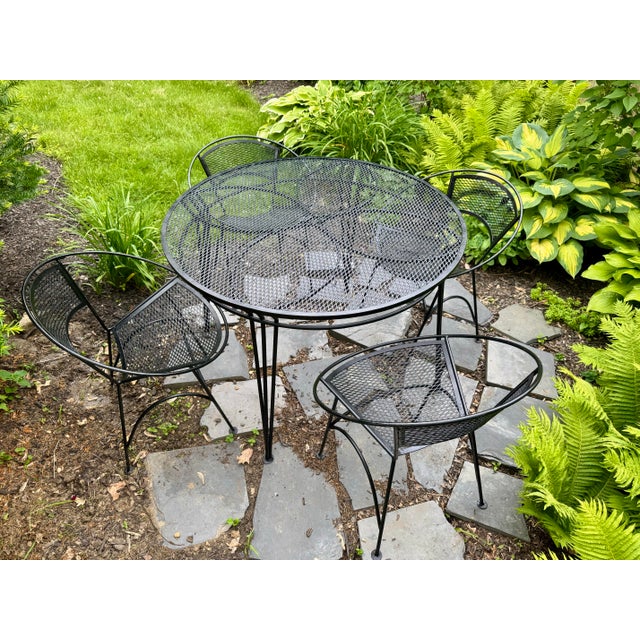 1950s iron patio set by Maurizio Tempestini for Salterini. Set features 4 classic radar style chairs with mesh seat and...